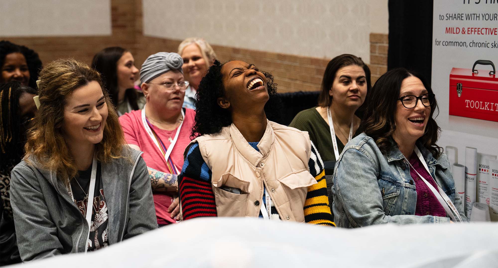 women laughing at a demo and having a good time